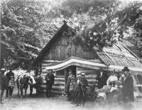 Posing in front of log cabin